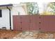 Red wooden gate leading to the backyard, stone pathway at 6372 Morehead Rd, Harrisburg, NC 28075