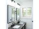 Modern bathroom with double vanity, gray countertop, and black faucets at 6372 Morehead Rd, Harrisburg, NC 28075