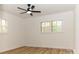 Bright bedroom with ceiling fan, hardwood floors, and window shutters at 6372 Morehead Rd, Harrisburg, NC 28075