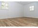 Light-filled bedroom featuring hardwood floors and window shutters at 6372 Morehead Rd, Harrisburg, NC 28075