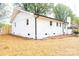 White brick home with black gutters and new landscaping at 6372 Morehead Rd, Harrisburg, NC 28075