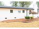 White brick ranch house with black shutters, landscaping, and a spacious yard at 6372 Morehead Rd, Harrisburg, NC 28075