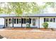 White brick front exterior with black shutters, porch, and stone walkway at 6372 Morehead Rd, Harrisburg, NC 28075