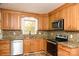 Modern kitchen with wood cabinets, granite countertops, and stainless steel appliances at 6372 Morehead Rd, Harrisburg, NC 28075