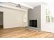 Living room featuring hardwood floors and a gray brick fireplace at 6372 Morehead Rd, Harrisburg, NC 28075