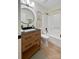 Updated bathroom with light wood vanity, black fixtures, framed art, and a shower-tub combo with curtain rod at 9027 Twin Trail Dr, Huntersville, NC 28078