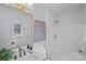 Well-lit bathroom with modern fixtures, a large mirror, and shower with white tile at 9027 Twin Trail Dr, Huntersville, NC 28078