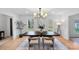 Stylish dining area with a dark wood table, four chairs and natural light from the windows offering green outdoor views at 9027 Twin Trail Dr, Huntersville, NC 28078