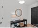 Inviting foyer with a modern round mirror, a stylish console table, and a sleek black front door, creating an elegant entrance at 9027 Twin Trail Dr, Huntersville, NC 28078