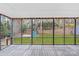 Enjoy the view of the backyard from this screened in porch with wood flooring and string lights at 9027 Twin Trail Dr, Huntersville, NC 28078