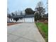 Modern home with white exterior, black accents, and large driveway at 914 30Th Avenue Nw Dr # 1, Hickory, NC 28601