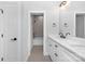 Bathroom with double vanity, white cabinets, and black fixtures at 1000 Fairground St, Charlotte, NC 28208