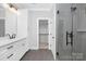 Elegant bathroom with white cabinets, quartz countertops, and walk-in shower at 1000 Fairground St, Charlotte, NC 28208