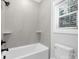 Bathroom with bathtub, shower, and neutral-toned tile at 1000 Fairground St, Charlotte, NC 28208