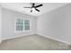 Bright bedroom with neutral walls, ceiling fan, and carpeted floor at 1000 Fairground St, Charlotte, NC 28208