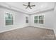 Spacious bedroom with neutral walls, ceiling fan, and carpeted floor at 1000 Fairground St, Charlotte, NC 28208