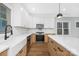 Modern kitchen features white cabinets, herringbone backsplash, and quartz countertops at 1000 Fairground St, Charlotte, NC 28208