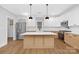 Modern kitchen with white cabinets, herringbone backsplash, and large island at 1000 Fairground St, Charlotte, NC 28208