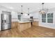 Modern kitchen with white cabinets, herringbone backsplash, and large island at 1000 Fairground St, Charlotte, NC 28208