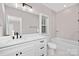 Modern bathroom with white vanity, bathtub, and updated fixtures at 1002 Fairground St, Charlotte, NC 28208