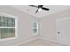 Bright bedroom with two windows, ceiling fan, and neutral wall colors at 1002 Fairground St, Charlotte, NC 28208