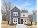 Two-story home with gray and white siding, and a paved driveway at 1002 Fairground St, Charlotte, NC 28208