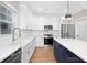 White kitchen with farmhouse sink, stainless steel appliances, and white cabinetry at 1002 Fairground St, Charlotte, NC 28208