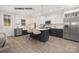 Modern kitchen with dark cabinetry, stainless steel appliances, and an island at 1002 Fairground St, Charlotte, NC 28208