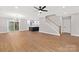 Open living area with hardwood floors and view of kitchen and stairs at 1002 Fairground St, Charlotte, NC 28208