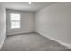 Well-lit bedroom with carpeted floors and a window at 105 Ciara Pl # A, Mooresville, NC 28117