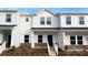 Charming two-story townhome featuring white siding, a dark front door, and a welcoming entryway at 105 Ciara Pl # B, Mooresville, NC 28117