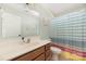 Bathroom with wood vanity and colorful striped shower curtain at 160 Hedgewood Dr, Mooresville, NC 28115