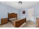 Bedroom with wood bed frame and light blue walls at 160 Hedgewood Dr, Mooresville, NC 28115