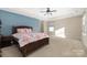 Bright bedroom with a ceiling fan and large window at 160 Hedgewood Dr, Mooresville, NC 28115