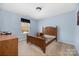 Bedroom with wood bed frame and light blue walls at 160 Hedgewood Dr, Mooresville, NC 28115