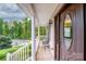 Front porch with white columns, seating, and a dark brown front door at 160 Hedgewood Dr, Mooresville, NC 28115