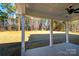Covered back patio with a ceiling fan and large columns overlooks a wooded backyard at 1865 Rock Hill Church Rd # 3, Matthews, NC 28104