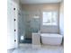 Bathroom features marble walk-in shower, soaking tub with window, and tile flooring at 1865 Rock Hill Church Rd # 3, Matthews, NC 28104