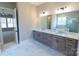 Primary bathroom featuring double sink vanity, marble countertops, tile floor, and soaker tub at 1865 Rock Hill Church Rd # 3, Matthews, NC 28104