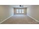 Spacious carpeted bedroom with large window and neutral walls at 1865 Rock Hill Church Rd # 3, Matthews, NC 28104
