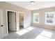 Neutral bedroom featuring carpet, white trim, windows with natural light, and en suite bathroom at 1865 Rock Hill Church Rd # 3, Matthews, NC 28104