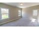 Bright bedroom with neutral paint, trim, carpet and two sun-filled, white-trimmed windows at 1865 Rock Hill Church Rd # 3, Matthews, NC 28104