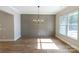 Modern dining room with wainscotting, a stylish chandelier, and a large window that offers natural light at 1865 Rock Hill Church Rd # 3, Matthews, NC 28104