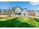 Inviting two-story home with a lush green lawn and mature trees, creating a serene setting at 1865 Rock Hill Church Rd # 3, Matthews, NC 28104