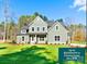 Charming two-story home featuring manicured lawn, complemented by verdant trees under clear blue skies at 1865 Rock Hill Church Rd # 3, Matthews, NC 28104