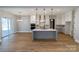 Open-concept kitchen with an island, pendant lighting, and a seamless transition to an inviting dining space at 1865 Rock Hill Church Rd # 3, Matthews, NC 28104