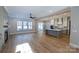 Open-concept living room and kitchen with wood floors, fireplace, large windows, and center island at 1865 Rock Hill Church Rd # 3, Matthews, NC 28104