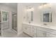 Bright bathroom with double sinks, framed mirrors, walk-in shower and modern vanity at 305 Pawley Dr, Charlotte, NC 28214