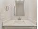 This powder room features a modern square mirror, faucet, and sink in a neutral color palette at 305 Pawley Dr, Charlotte, NC 28214