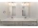 Bathroom vanity with double sinks, framed mirrors, and modern lighting fixtures at 305 Pawley Dr, Charlotte, NC 28214